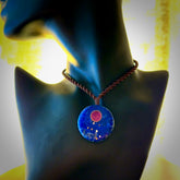 This photo shows a medium sized disc pendant hand carved from Lapis Lazuli with Sugilite inlay and copper, gold, and silver. This is a stand out one off necklace for those who appreciate art to wear. It is provided with a cord in black that is a fixed length with Paua Shell Toggle. We ship this piece worldwide and shipping is included in the price.